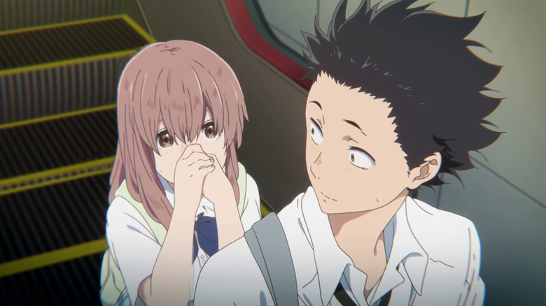 Shōya glances at Shōko on the escalator behind him in A Silent Voice