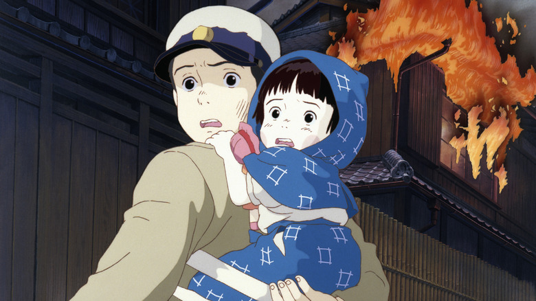 Seita carries Setsuko through a burning city in Grave of the Fireflies