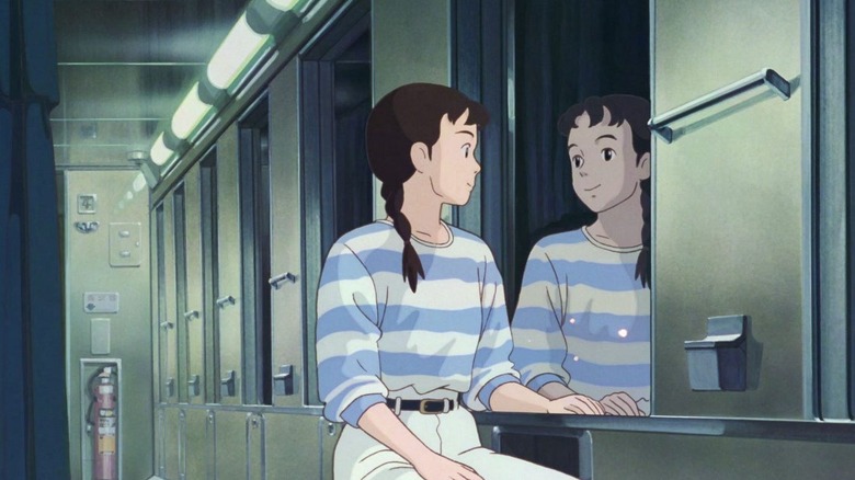 Taeko smiles at her reflection in a window in Only Yesterday