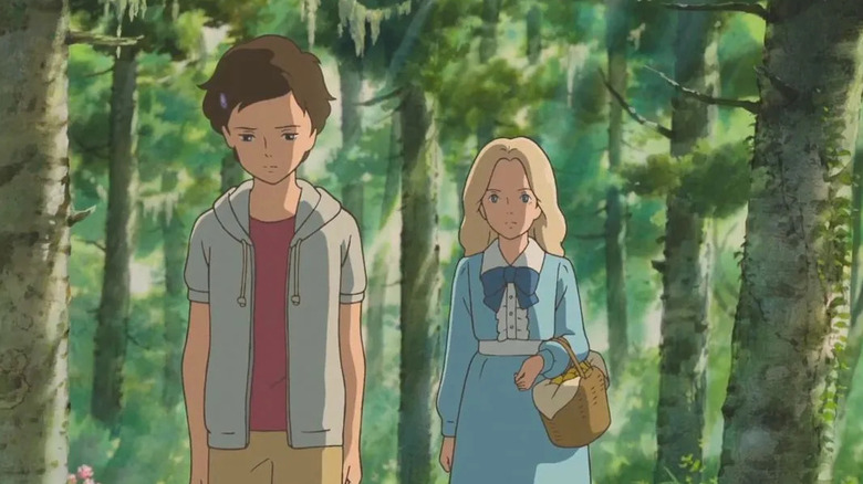 Marnie walks behind Anna in a forest in When Marnie Was There