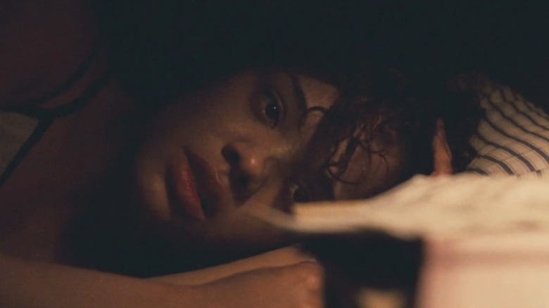 Tessa Thompson as Kari Peterson lying in bed with an anguished expression in Mississippi Damned