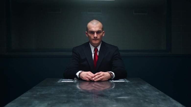 Rupert Friend as Agent 47, sitting handcuffed to an interrogation table in Hitman: Agent 47