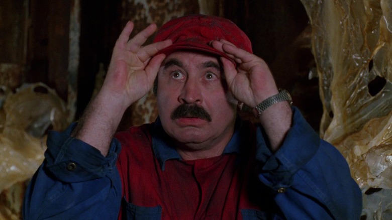 Bob Hoskins as Mario, adjusting his cap in the 1993 Super Mario Bros. film