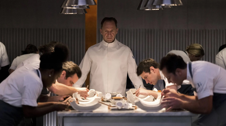 Ralph Fiennes watching chefs in The Menu