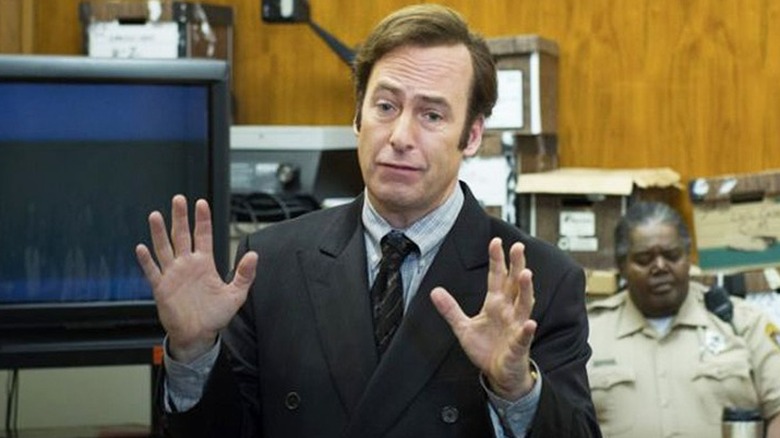 Jimmy McGill in front of TV Better Call Saul
