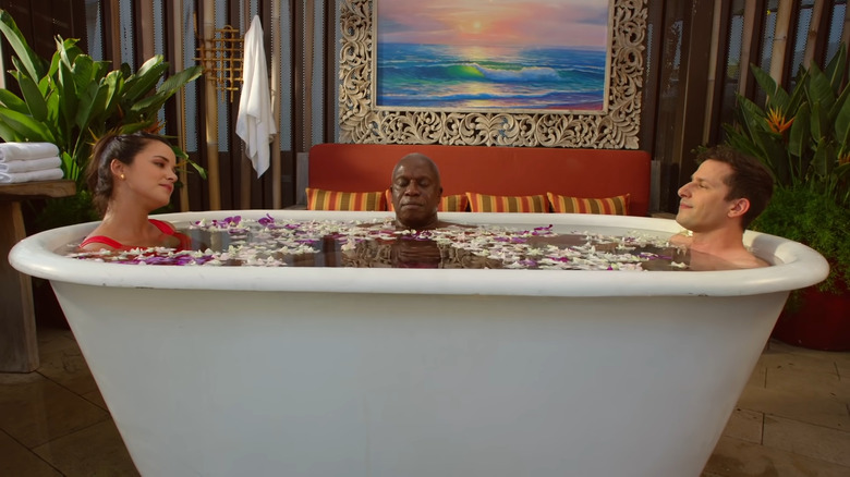 Amy Santiago and Jake Peralta in jacuzzi with Capt. Raymond Holt