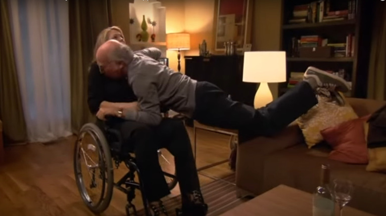 Larry David awkwardly embracing Denise