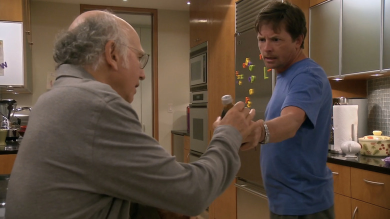 Larry David arguing with Michael J. Fox