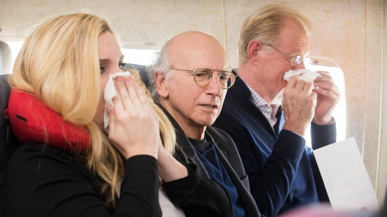 Larry David sitting on airplane