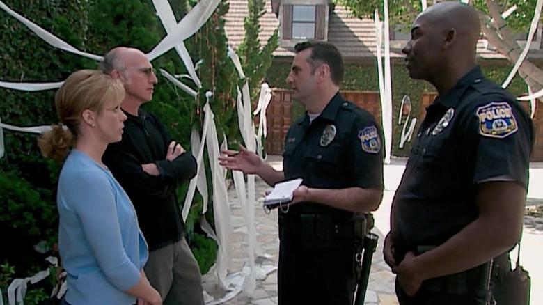 Larry David and Cheryl Hines talking to cops