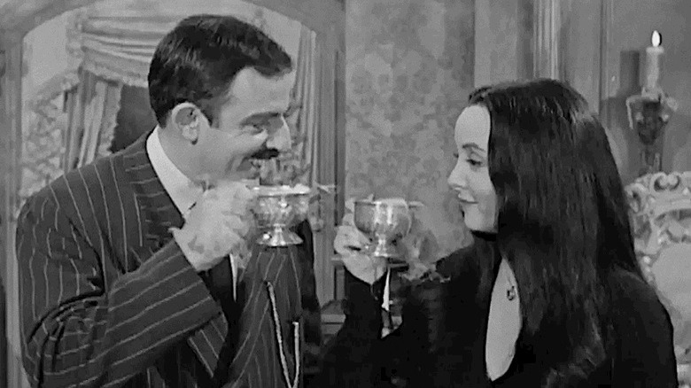 Gomez and Morticia Addams share a drink.