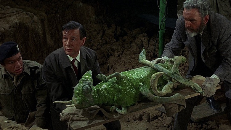 Bernard and a friend examine an alien corpse