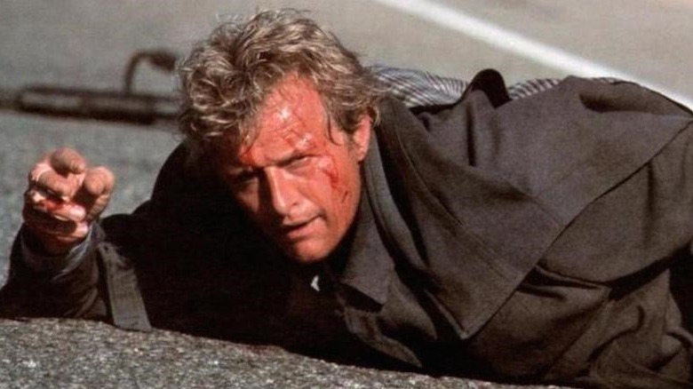 Rutger Hauer lying on a road