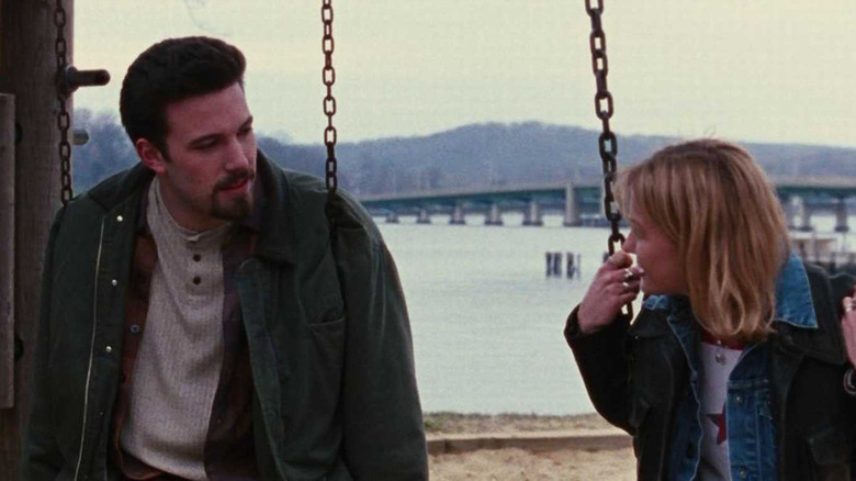 Ben Affleck sitting on a swing with Joey Lauren Adams