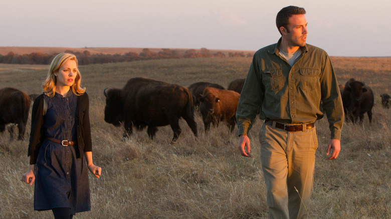 Ben Affleck and Rachel McAdams walking in a field