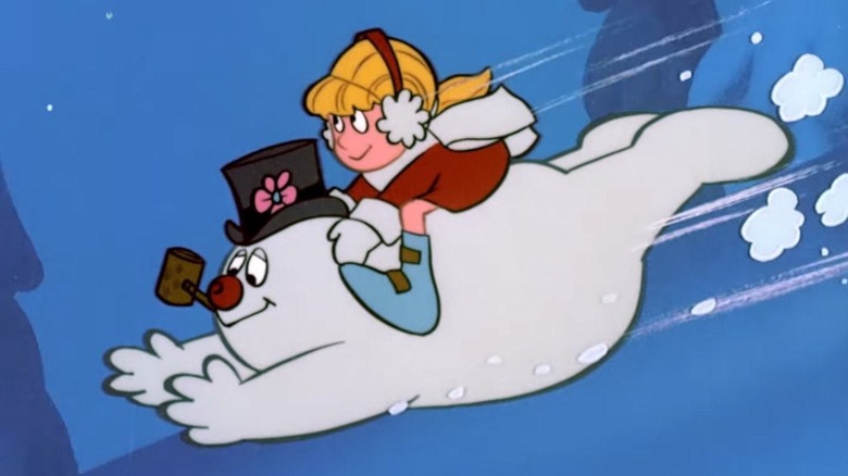 Karen sits on the back of Frosty who slides down a hill on his stomach in Frosty the Snowman.