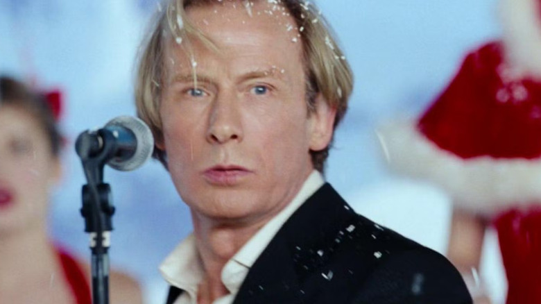 Bill Nighy as Billy Mack striking a pose while performing in Love Actually