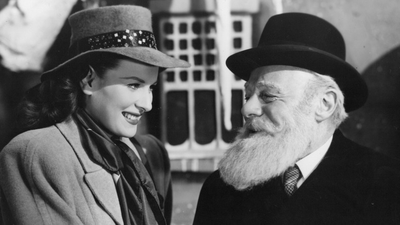 Maureen O'Hara as Doris Walker and Edmund Gwenn as Kris Kringle share a laugh in A Miracle on 34th Street.