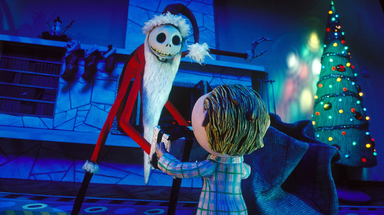 Jack Skellington dressed in a Santa suit giving a child a Christmas present in The Nightmare Before Christmas.