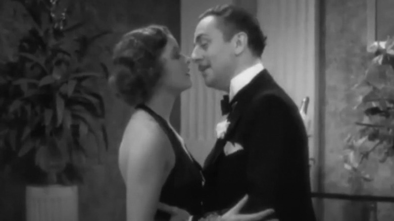 Nick and Nora embrace each other and nearly kiss in The Thin Man