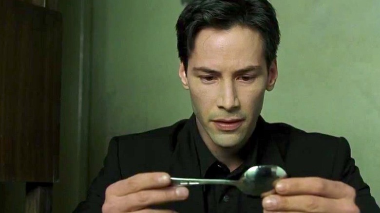 Neo inspects a spoon