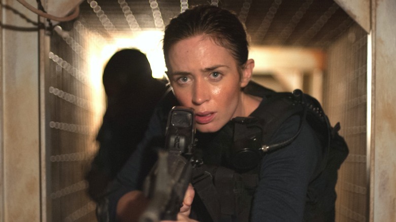 Emily Blunt sweeps the tunnel for threats.