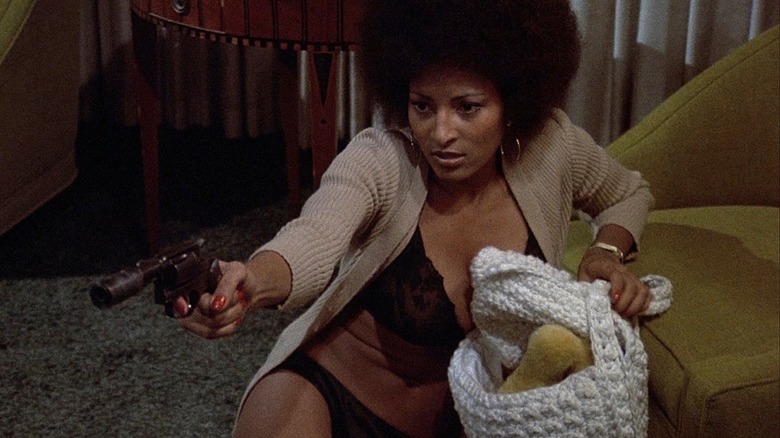 Pam Grier holds a gun