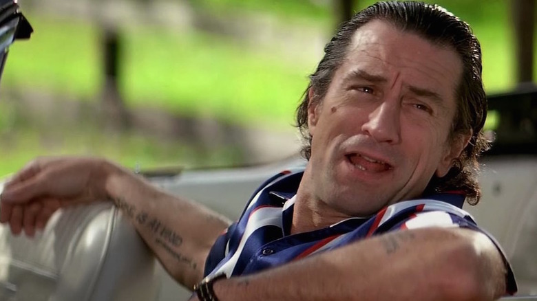 Tattooed Robert de Niro drives convertible