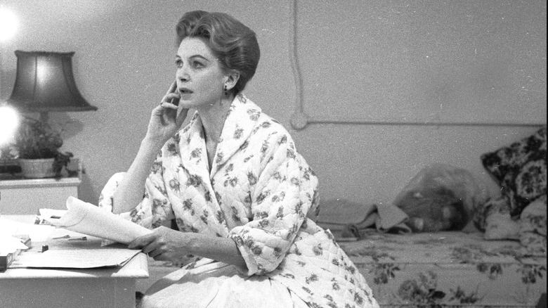 woman sitting at desk in The Innocents