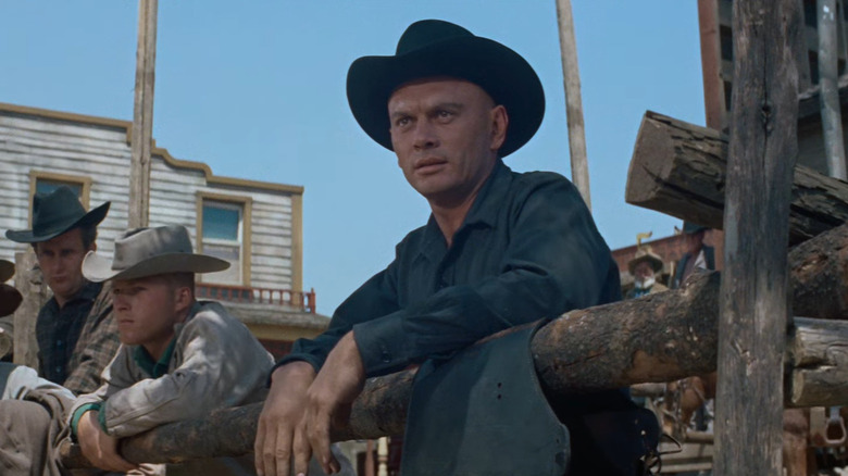 Yul Brynner leaning on fence post