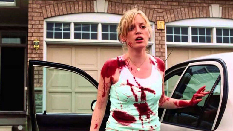 Sarah Polley stands outside house scared and covered in blood
