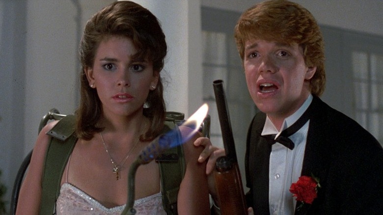 Two teens in formalwear armed with a blowtorch