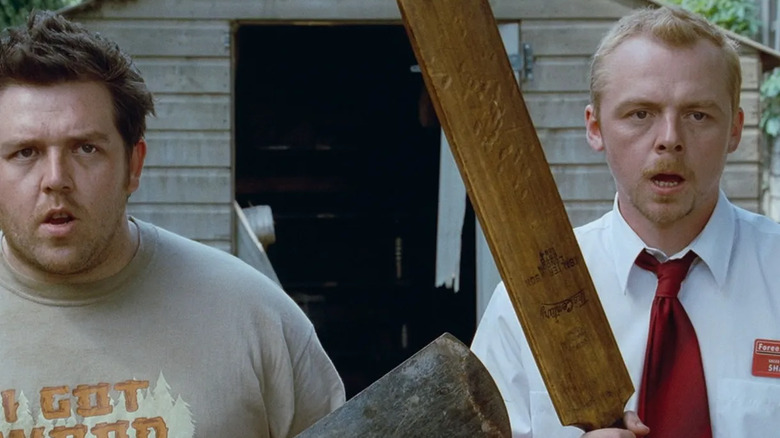 Simon Pegg and Nick Frost stand with cricket bats as weapons