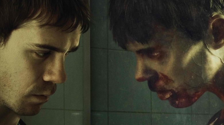 Men looks at zombie reflection in mirror