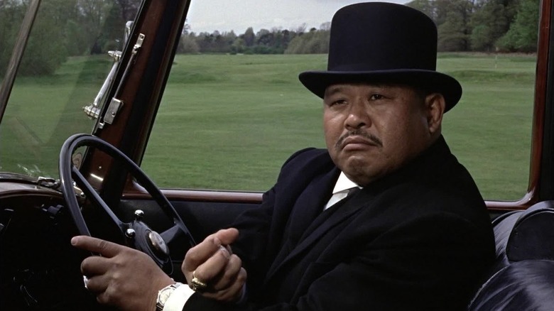 Oddjob drives a car