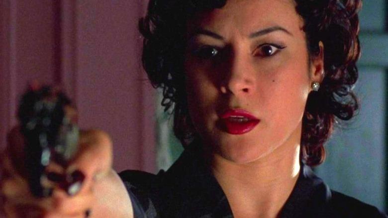 Jennifer Tilly holding a gun