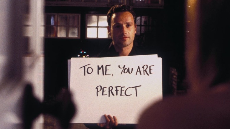 Mark from Love Actually holding cue cards