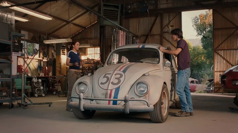 Maggie and Kevin standing next to Herbie