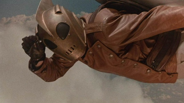 The Rocketeer making a salute while flying