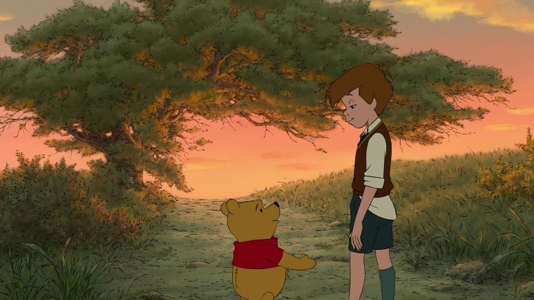 Winnie the Pooh and Christopher Robin standing in path