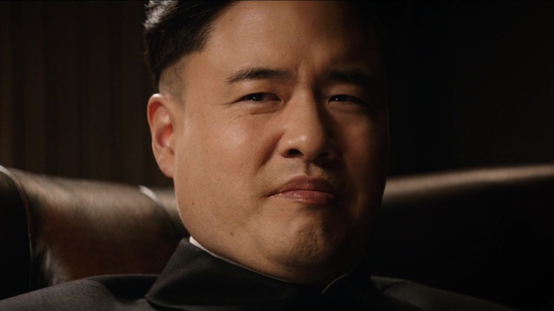 Randall Park's Kim Jong Un smiles in closeup in The Interview