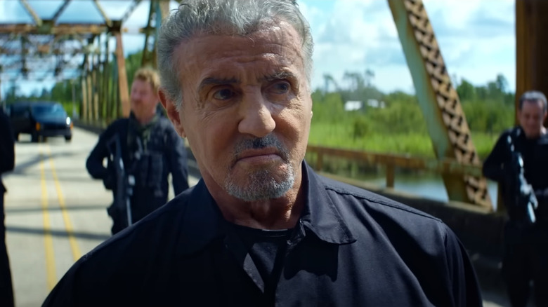 Sylvester Stallone as Rook standing on a bridge in Armor