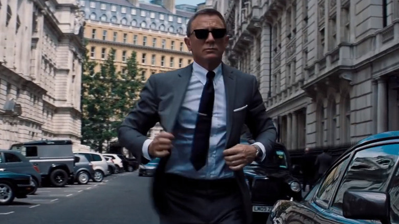 Daniel Craig's James Bond walking in the street in his grey suit in No Time to Die