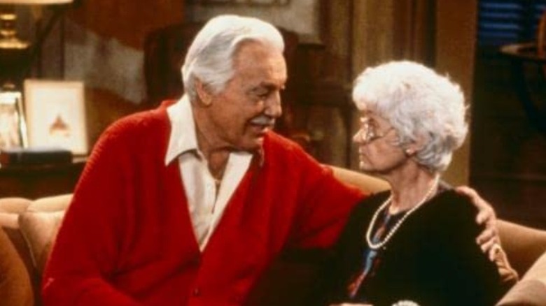 Estelle Getty and Cesar Romero seated on a sofa