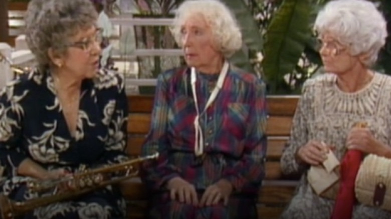 Estelle Getty looking at woman with trumpet