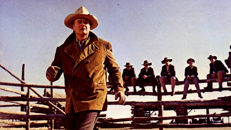 John Wayne walking away from teen cowboys