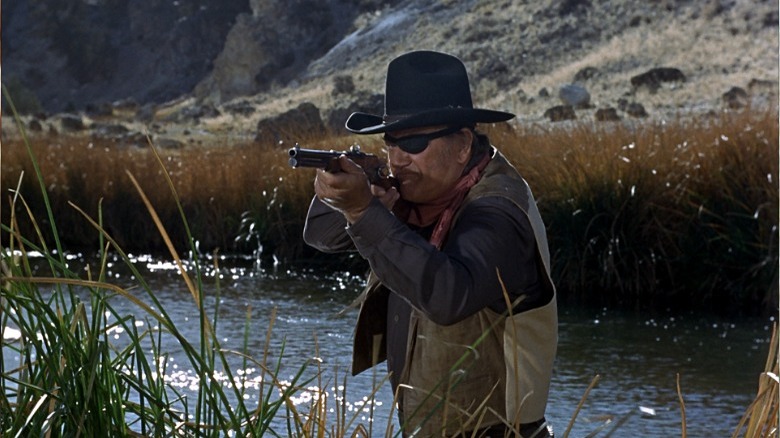 John Wayne aims shotgun True Grit