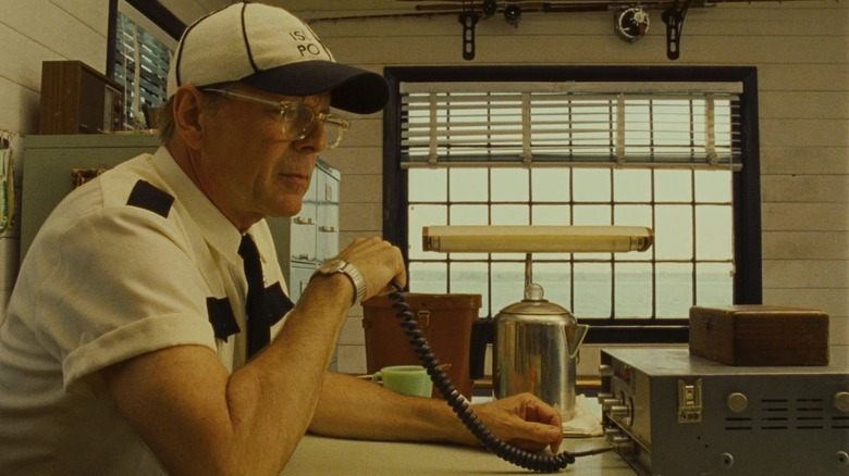 Bruce Willis as Captain Sharp sitting in his office in Moonrise Kingdom