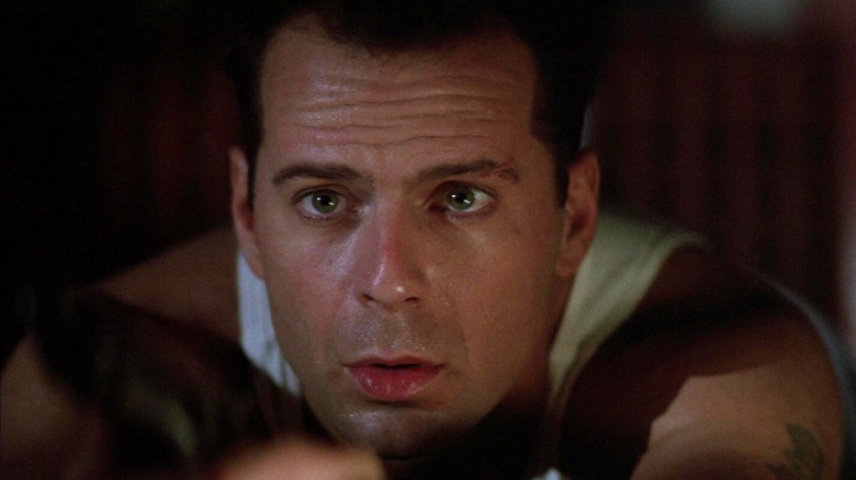 Bruce Willis as John McClane who looked worried in Die Hard