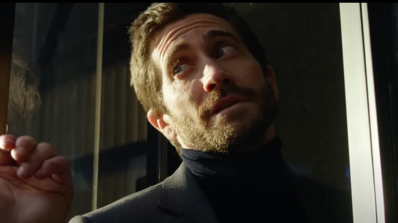 Jake Gyllenhaal as Danny cocks his head by a door in Ambulance